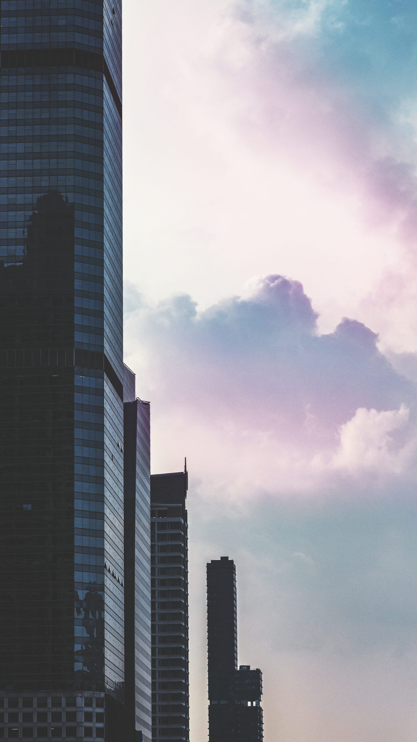 skyscraper under cotton candy sky mobile phone wallpaper